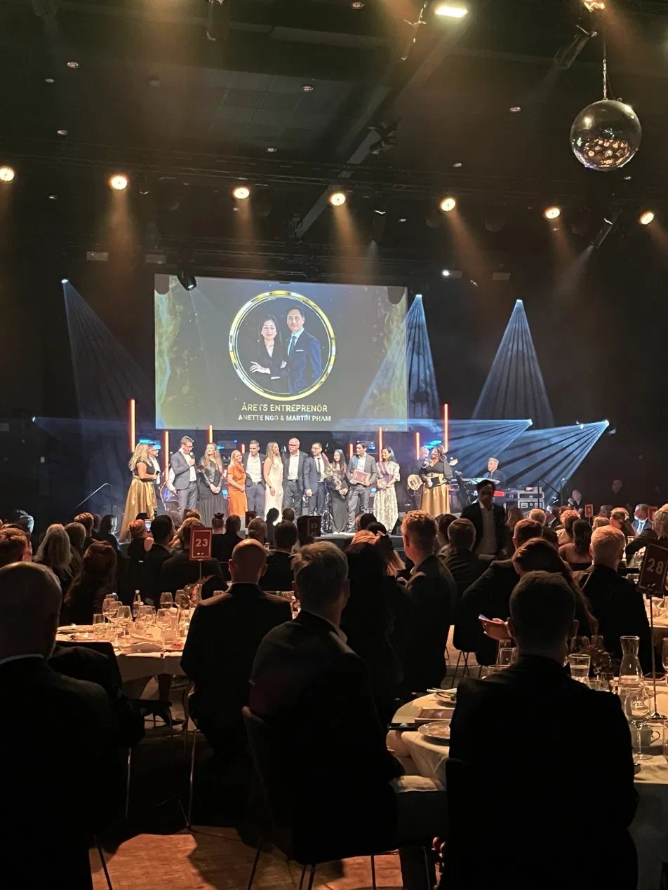 Awards on stage at the MiH annual gala, with guests at round tables