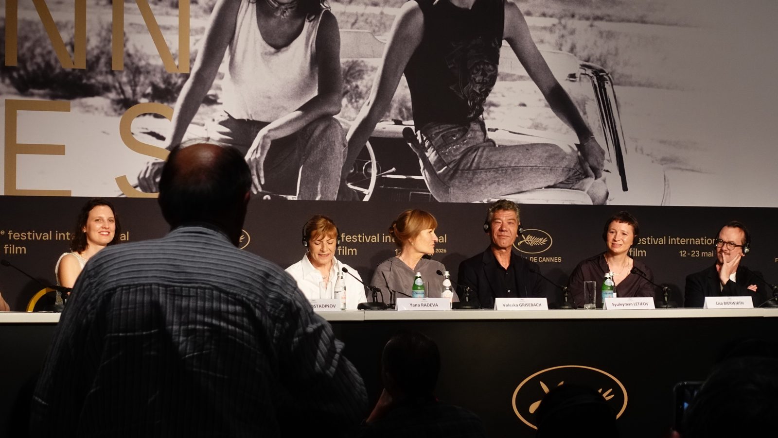 A journalist stands to ask a question at a Cannes press conference