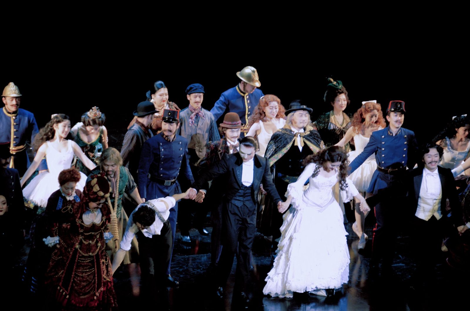 Full cast of a musical taking a curtain call